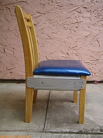 Strange looking aluminum, vinyl, and wood chair